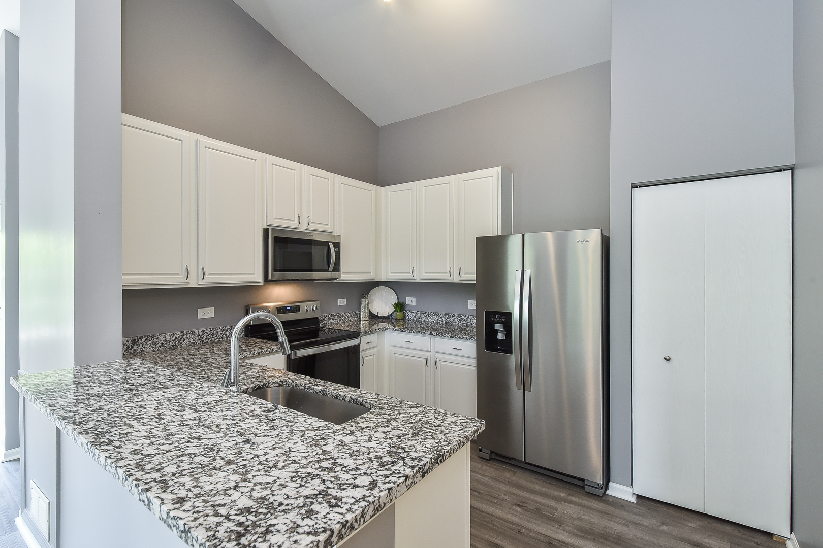 1556 McClure Road, Unit 1556 Aurora, IL 60505 - Photo 6 of 17 a kitchen with a refrigerator and a sink