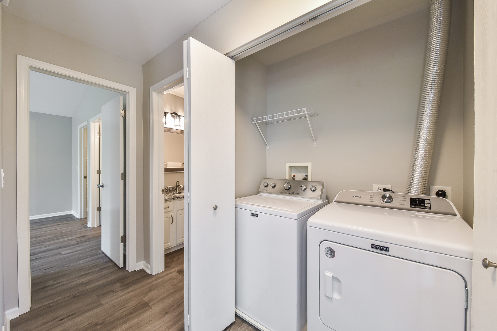 1556 McClure Road, Unit 1556 Aurora, IL 60505 - Photo 7 of 17 a view of washer and dryer with wooden floor