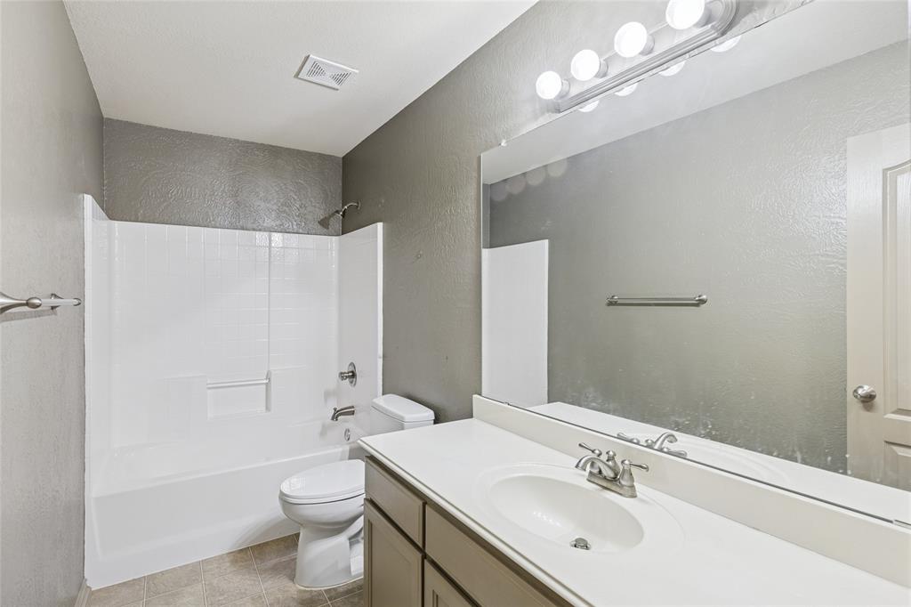 1749 Potomac Drive, Unit R Burleson, TX 76028 - Photo 14 of 15 a bathroom with a sink a toilet and shower