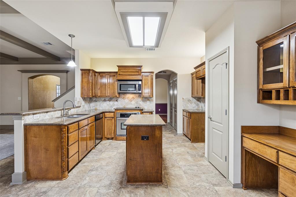 1749 Potomac Drive, Unit R Burleson, TX 76028 - Photo 6 of 15 a kitchen with stainless steel appliances granite countertop a stove oven and a refrigerator