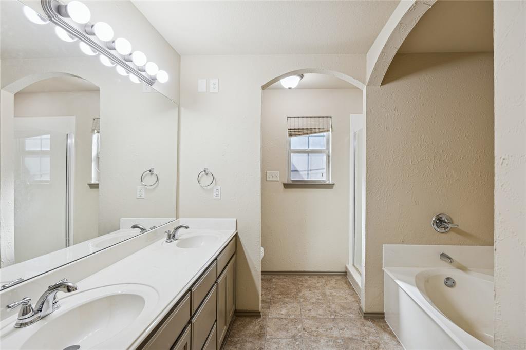 1749 Potomac Drive, Unit R Burleson, TX 76028 - Photo 9 of 15 a bathroom with a tub a sink and mirror