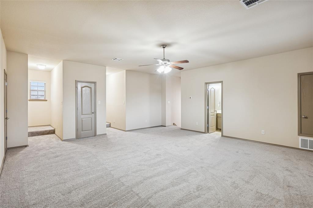 1749 Potomac Drive, Unit R Burleson, TX 76028 - Photo 10 of 15 an empty room with chandelier fan and windows