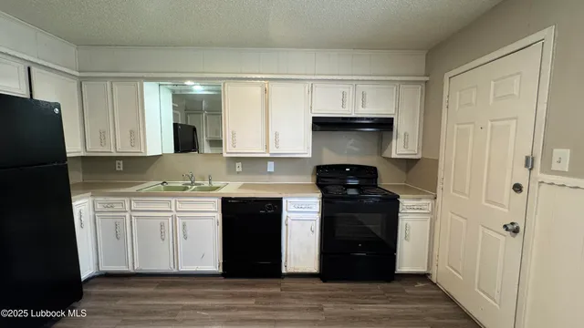 a kitchen with a stove and a refrigerator