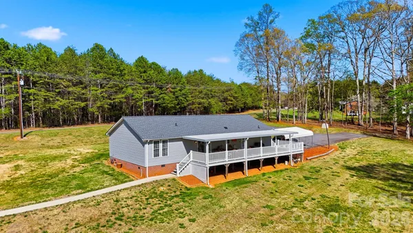 a aerial view of a house with swimming pool next to a yard