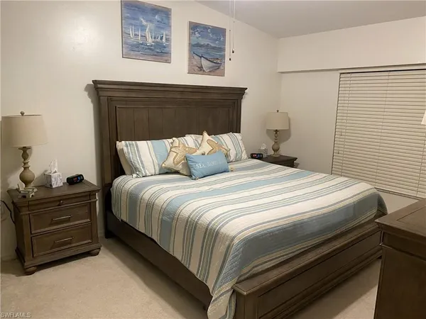 a bedroom with a bed and cabinet