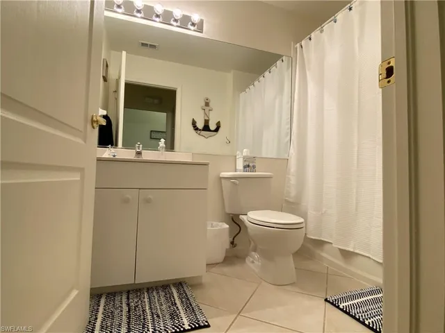 a bathroom with a toilet a sink and a mirror
