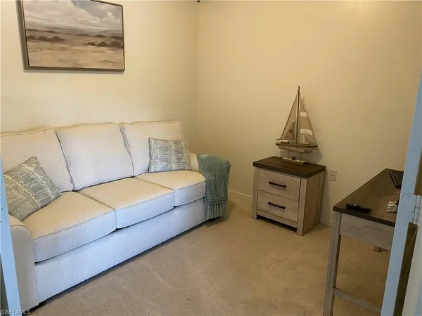 a living room with a couch and dresser