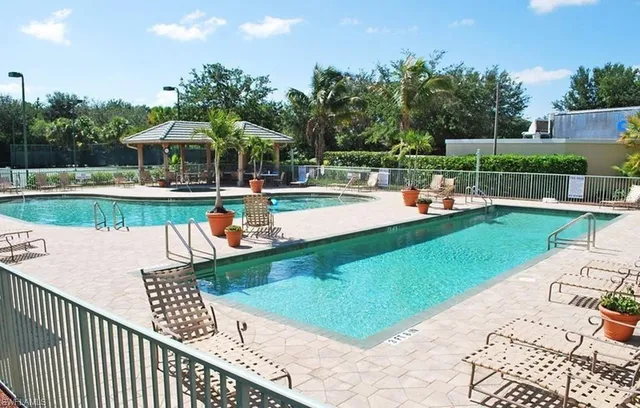 a view of a lake with lawn chairs