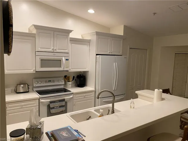 a kitchen with a sink appliances and cabinets