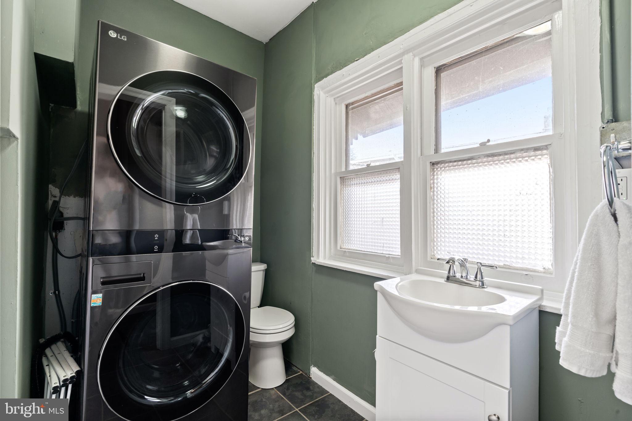 4751 Fowler Street Philadelphia, PA 19127 - Photo 17 of 26 a bathroom with a sink a washer and dryer