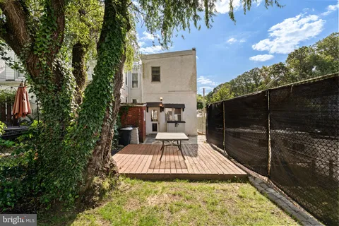 a view of a backyard with sitting area
