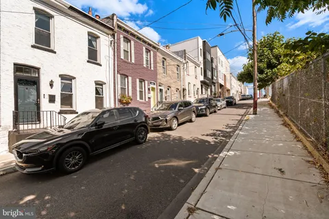a couple of cars parked in front of a building
