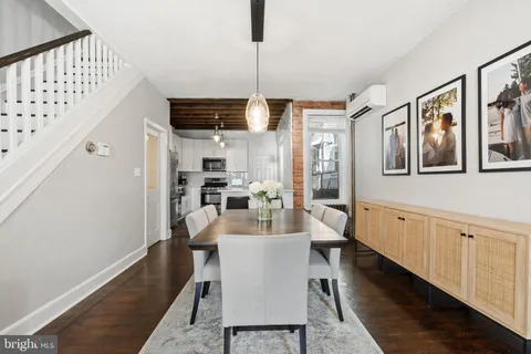 a very nice looking dining room with kitchen area