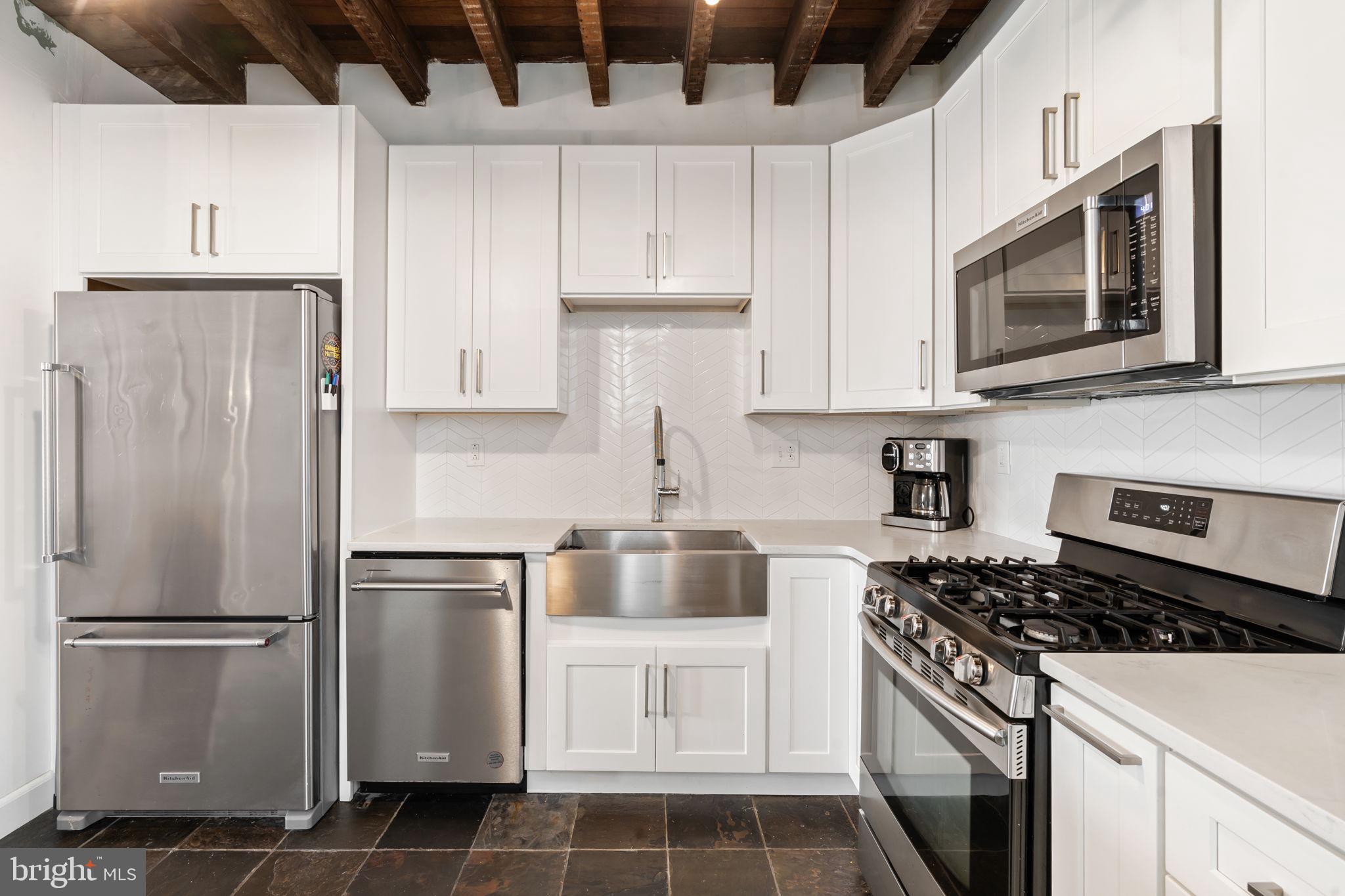 4751 Fowler Street Philadelphia, PA 19127 - Photo 7 of 26 a kitchen with appliances a refrigerator and cabinets