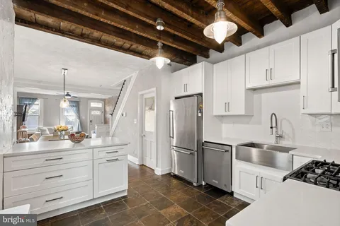 a kitchen with refrigerator and cabinets