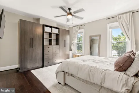 a bedroom with a bed and a large window