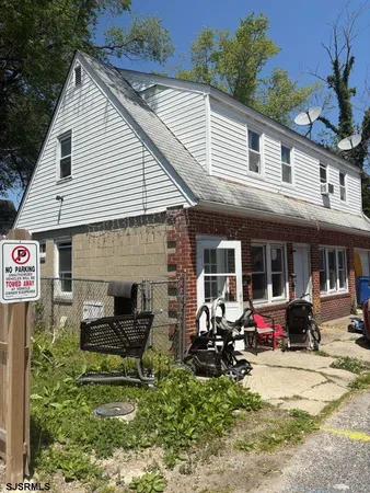 a view of a house with outdoor seating
