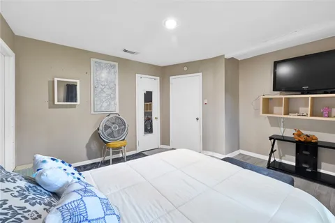 a bedroom with a bed and a flat screen tv