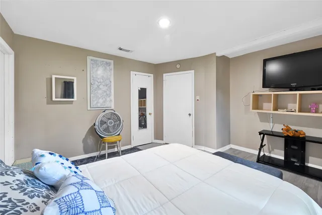 a bedroom with a bed and a flat screen tv