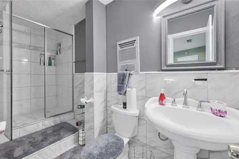 a bathroom with a sink toilet and shower