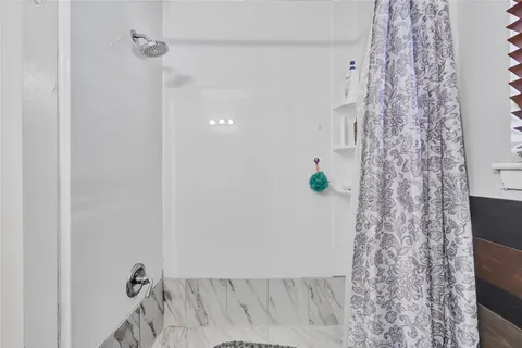 a bathroom with a shower curtain and a sink