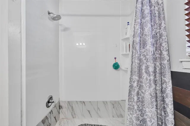 a bathroom with a shower curtain and a sink