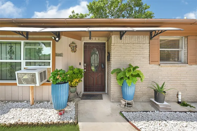 a view of front door of house with potted plant