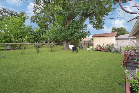 a backyard of a house with table and chairs