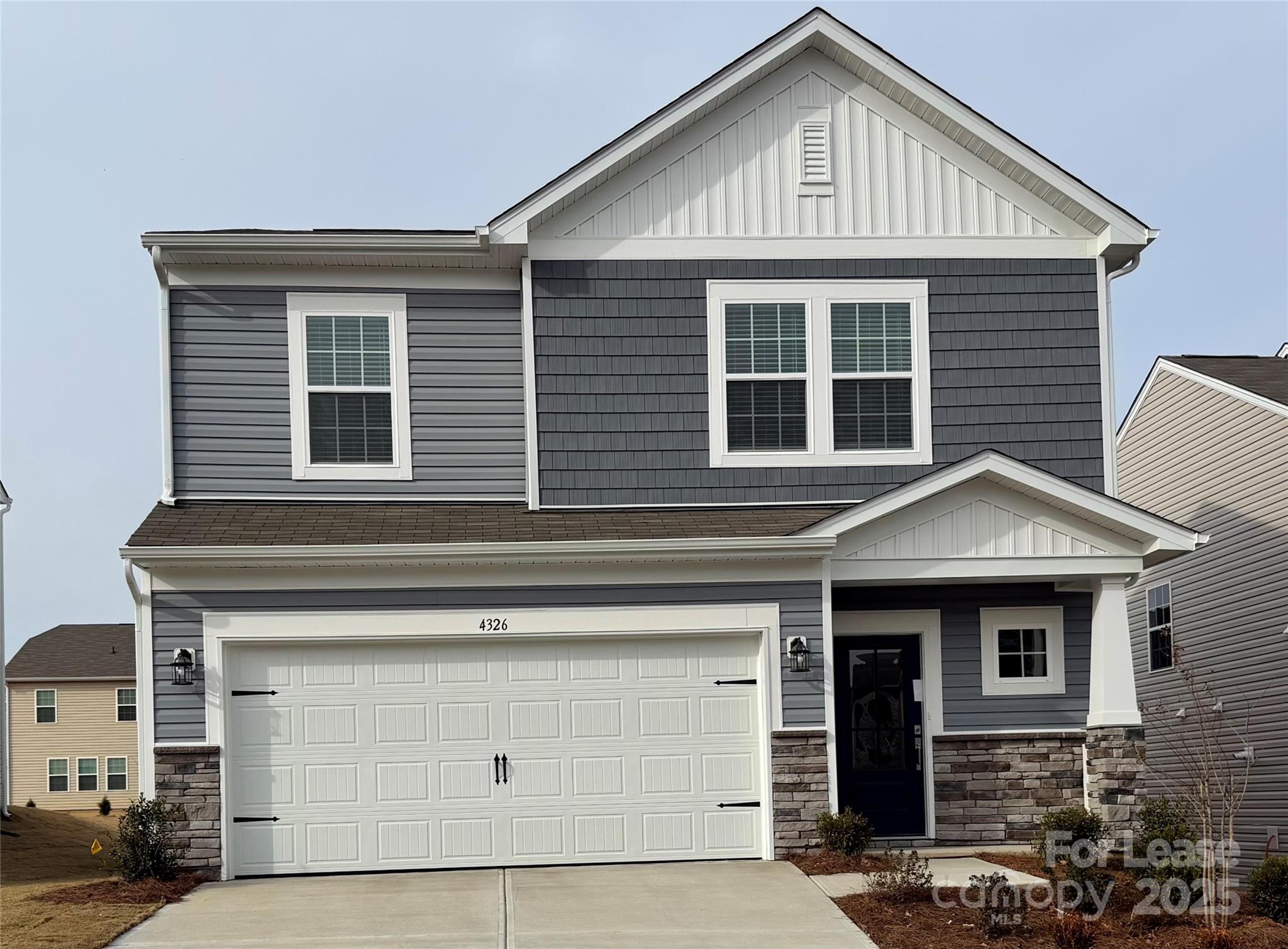 a front view of a house with garage