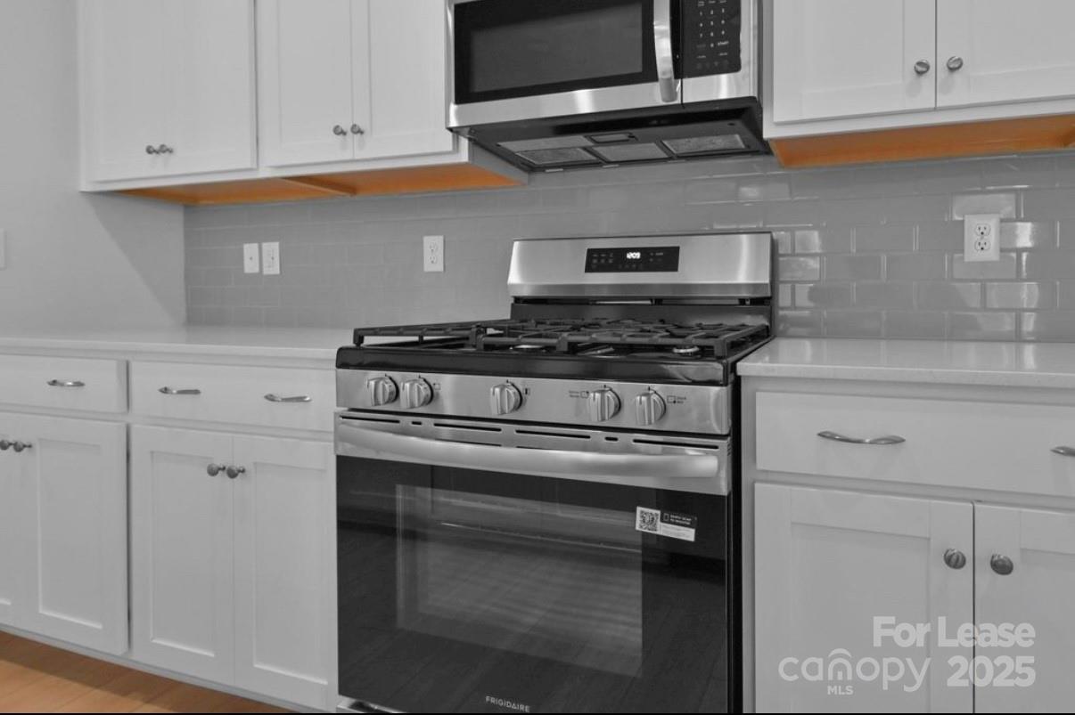 4326 Shimmering Stone Way Maiden, NC 28650 - Photo 11 of 27 a stove top oven sitting inside of a kitchen