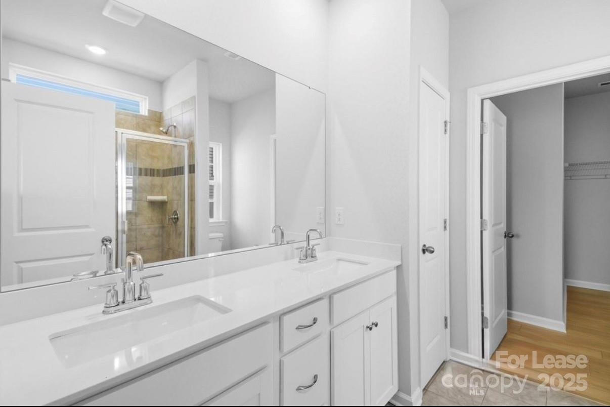 4326 Shimmering Stone Way Maiden, NC 28650 - Photo 14 of 27 a bathroom with a double vanity sink and a mirror