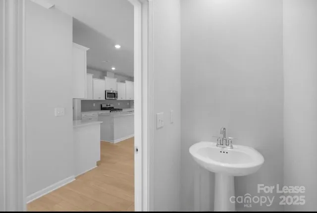 a bathroom with a sink a mirror and a toilet