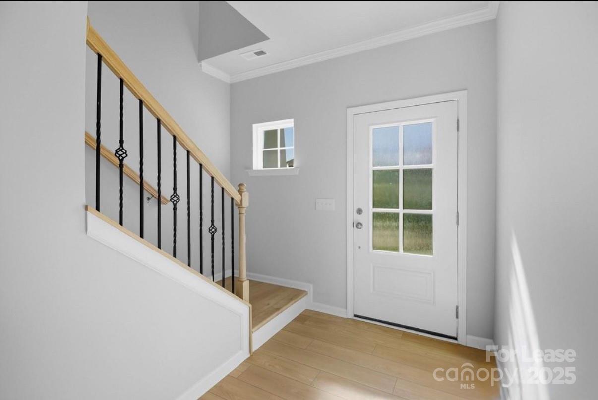 4326 Shimmering Stone Way Maiden, NC 28650 - Photo 3 of 27 a view of an entryway with wooden floor and windows