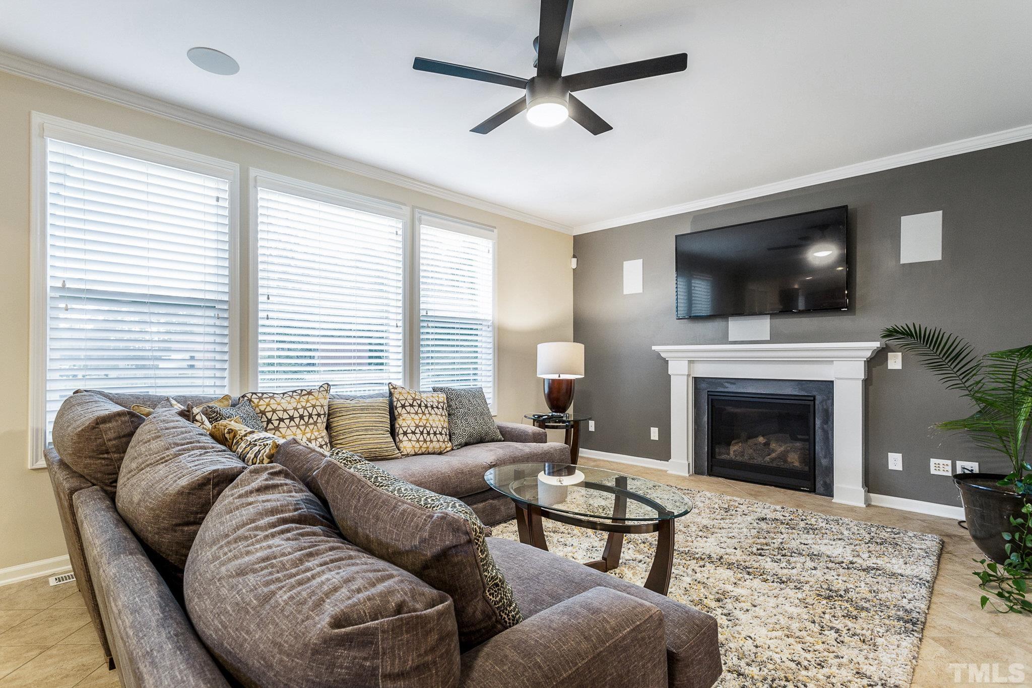 1214 Raleigh Street Oxford, NC 27565 - Photo 11 of 40 a living room with furniture a fireplace and a flat screen tv