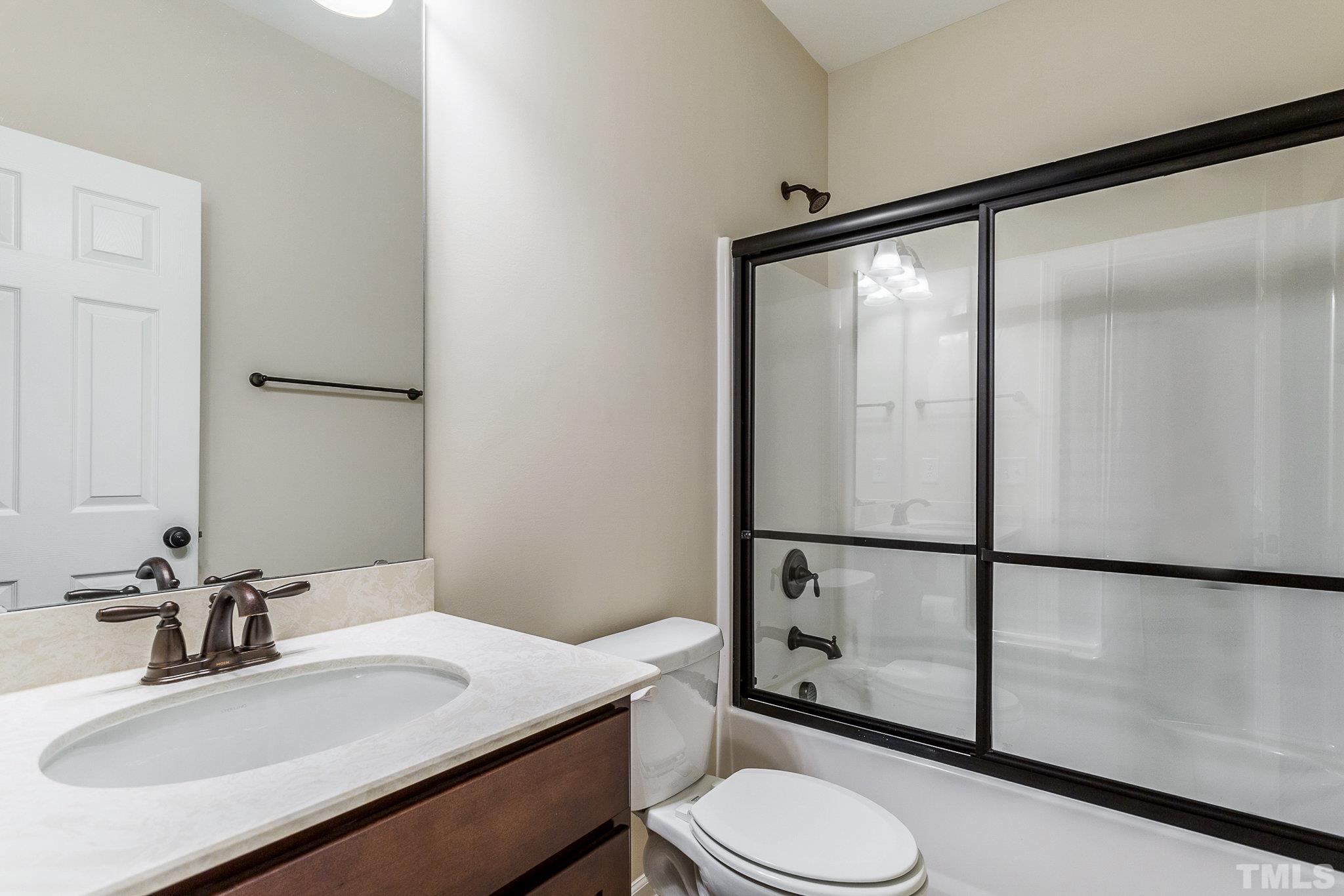 1214 Raleigh Street Oxford, NC 27565 - Photo 14 of 40 a bathroom with a sink toilet and mirror