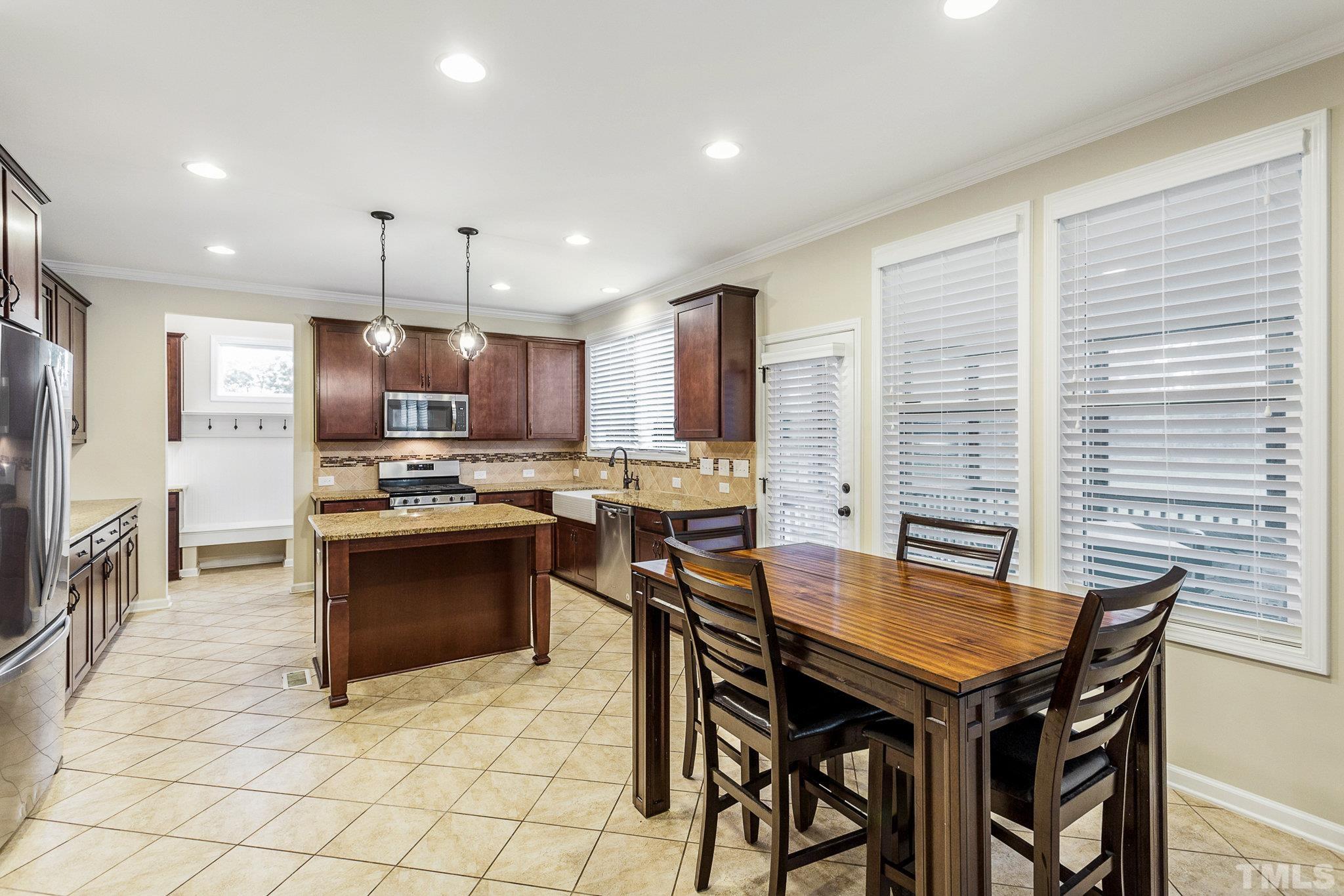 1214 Raleigh Street Oxford, NC 27565 - Photo 15 of 40 a kitchen with granite countertop a sink counter and stainless steel appliances