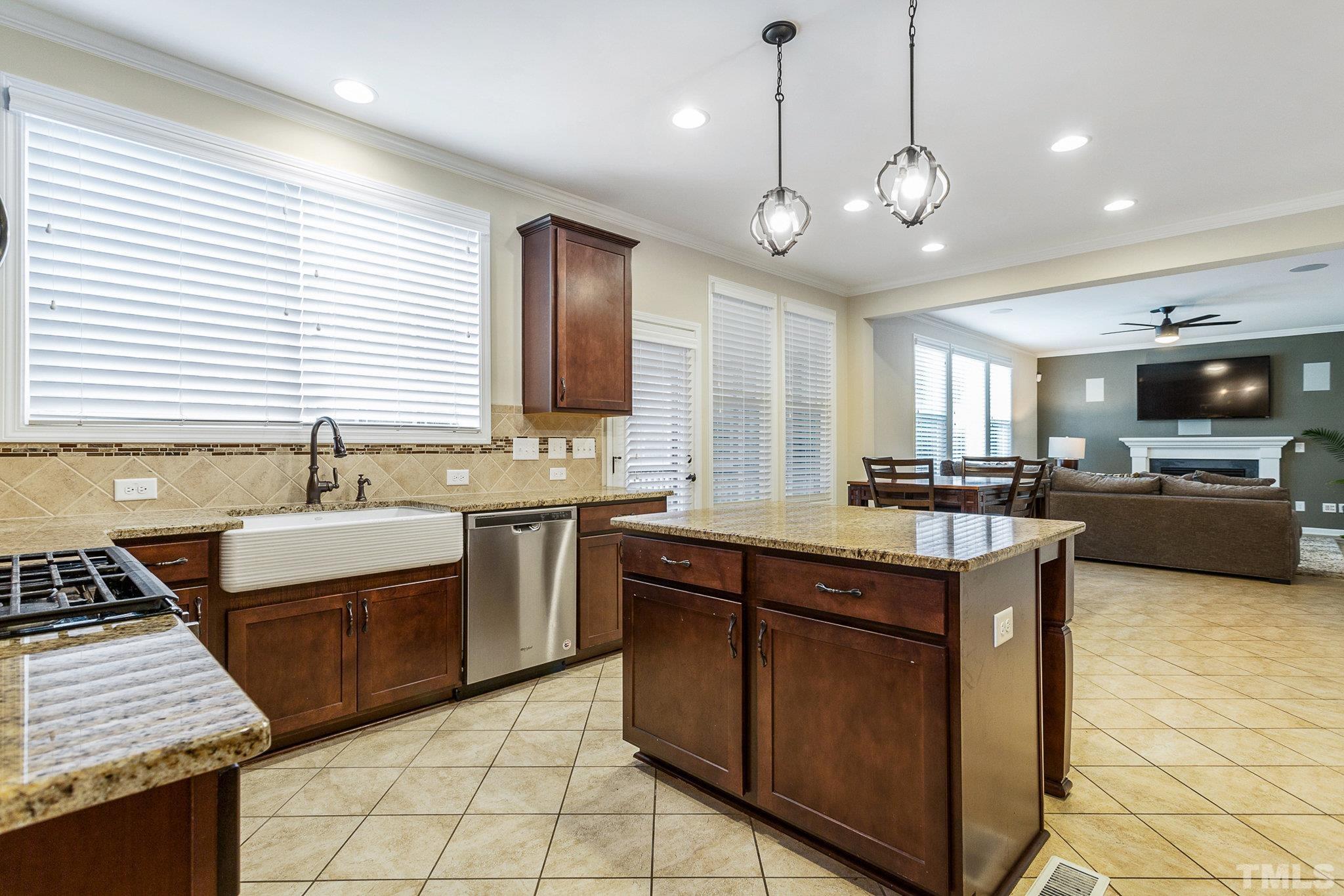1214 Raleigh Street Oxford, NC 27565 - Photo 20 of 40 a kitchen with stainless steel appliances granite countertop a sink a stove and a refrigerator