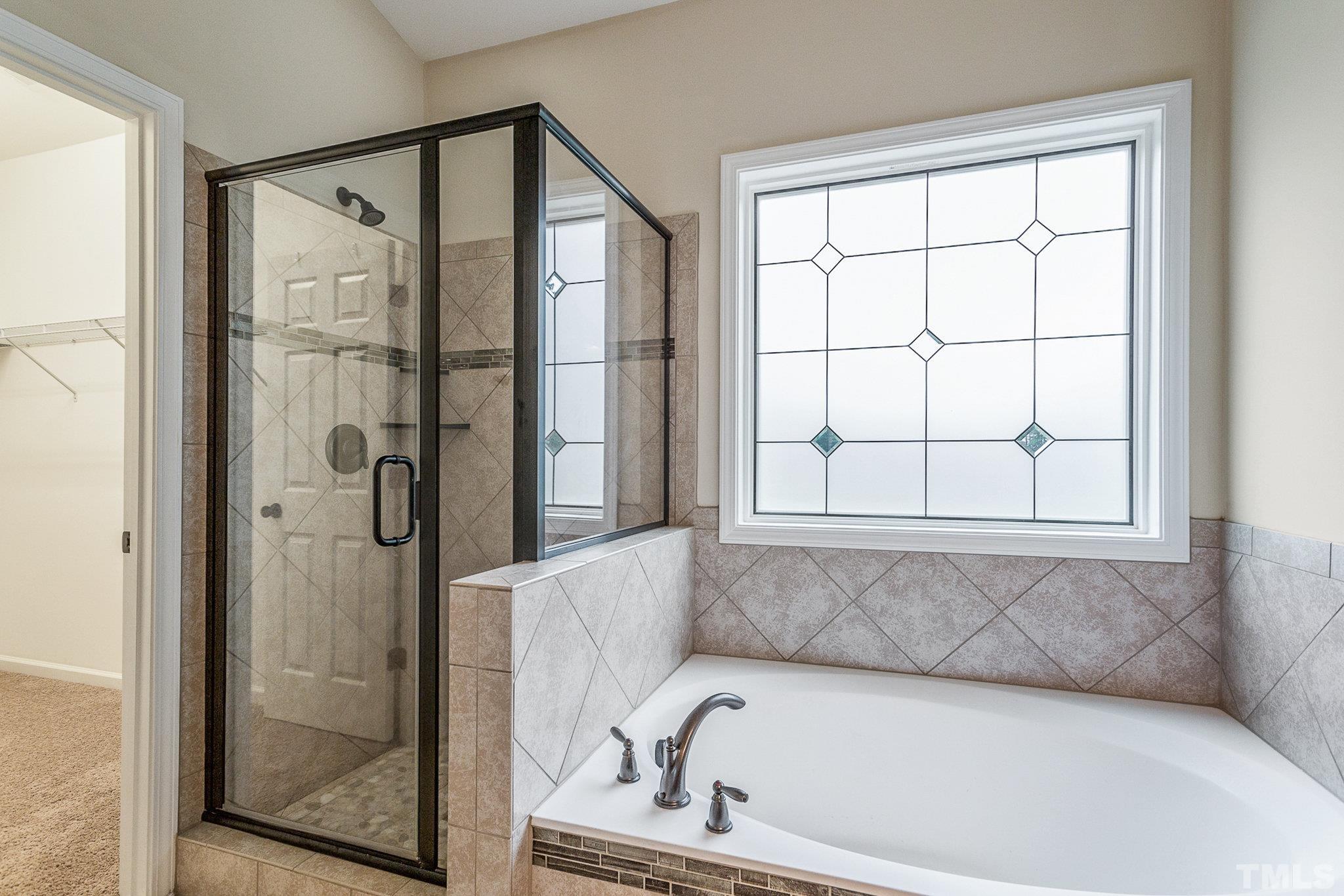 1214 Raleigh Street Oxford, NC 27565 - Photo 24 of 40 a bathroom with a bathtub and next to a window