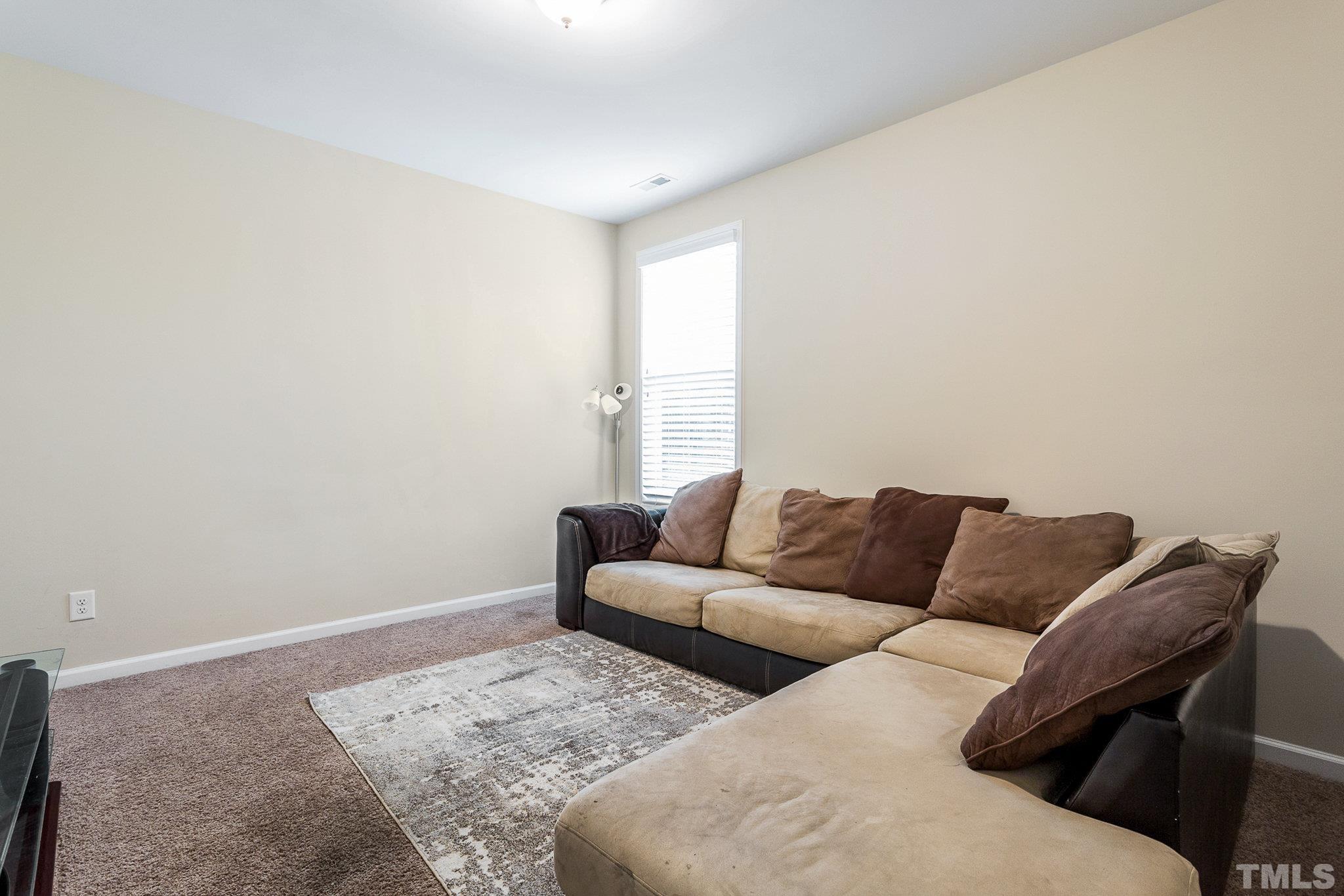 1214 Raleigh Street Oxford, NC 27565 - Photo 28 of 40 a living room with furniture and a window