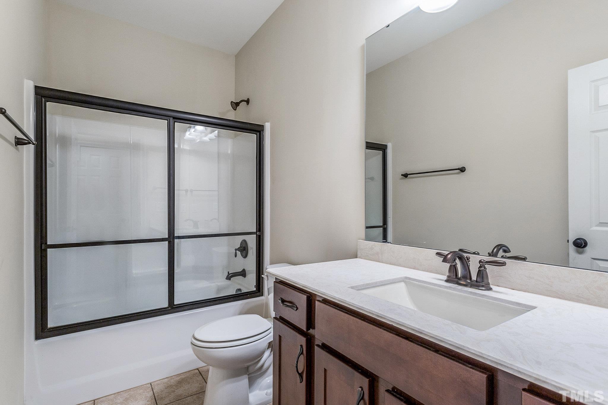 1214 Raleigh Street Oxford, NC 27565 - Photo 29 of 40 a bathroom with a sink toilet and mirror
