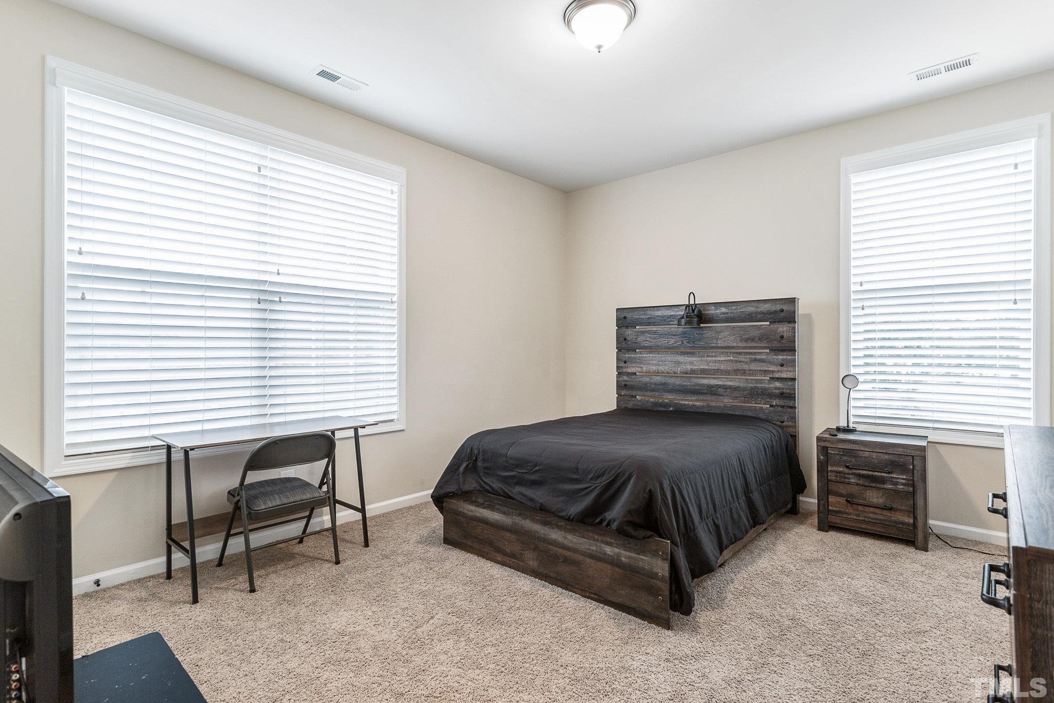 1214 Raleigh Street Oxford, NC 27565 - Photo 30 of 40 a bedroom with a bed and a window