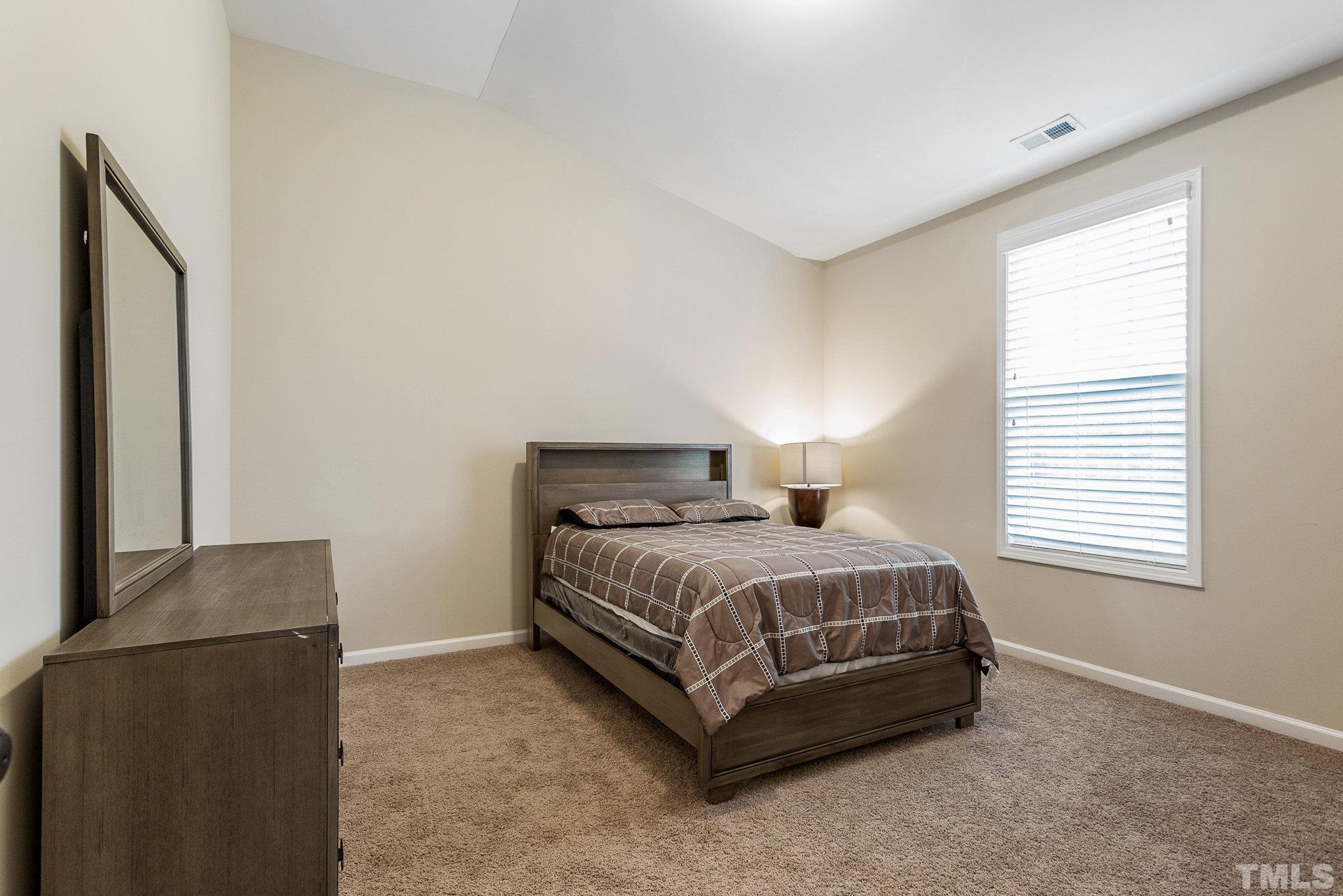 1214 Raleigh Street Oxford, NC 27565 - Photo 31 of 40 a bed sitting in a bedroom next to a window
