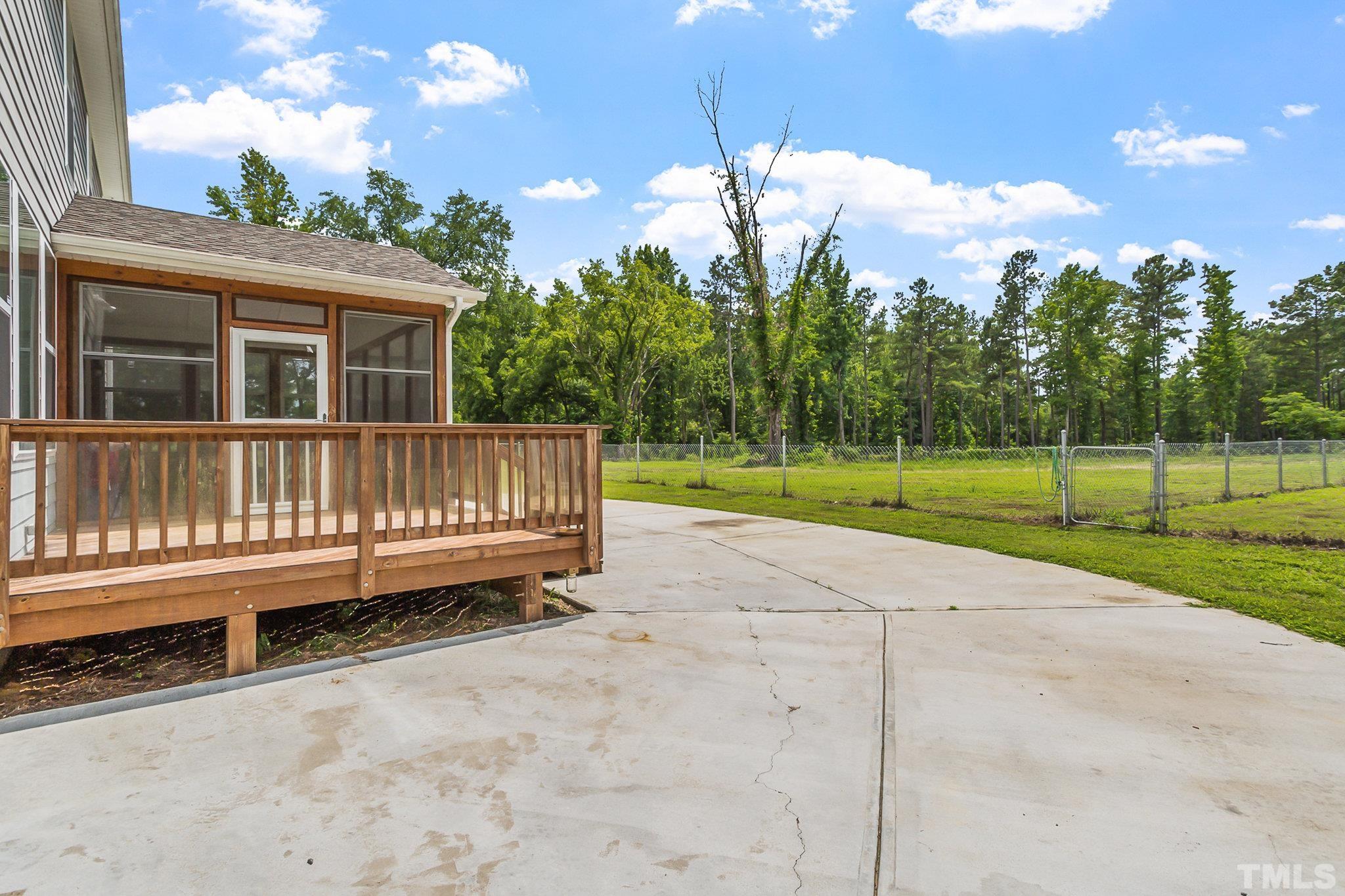 1214 Raleigh Street Oxford, NC 27565 - Photo 34 of 40 a view of a house with wooden deck and a yard