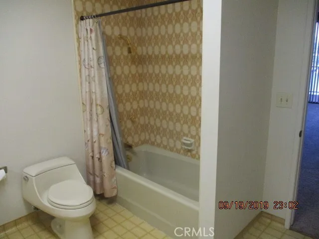 a bathroom with a toilet and shower
