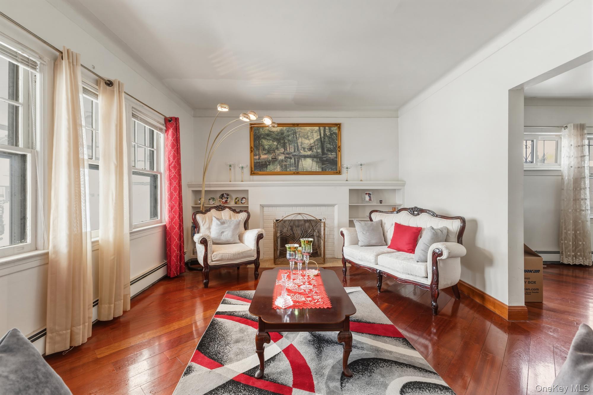 188-11 Dormans Road Queens, NY 11412 - Photo 2 of 32 a living room with furniture and a fireplace