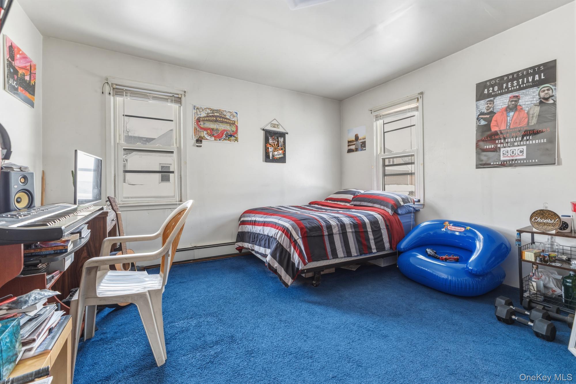 188-11 Dormans Road Queens, NY 11412 - Photo 22 of 32 a bedroom with a bed and a chair