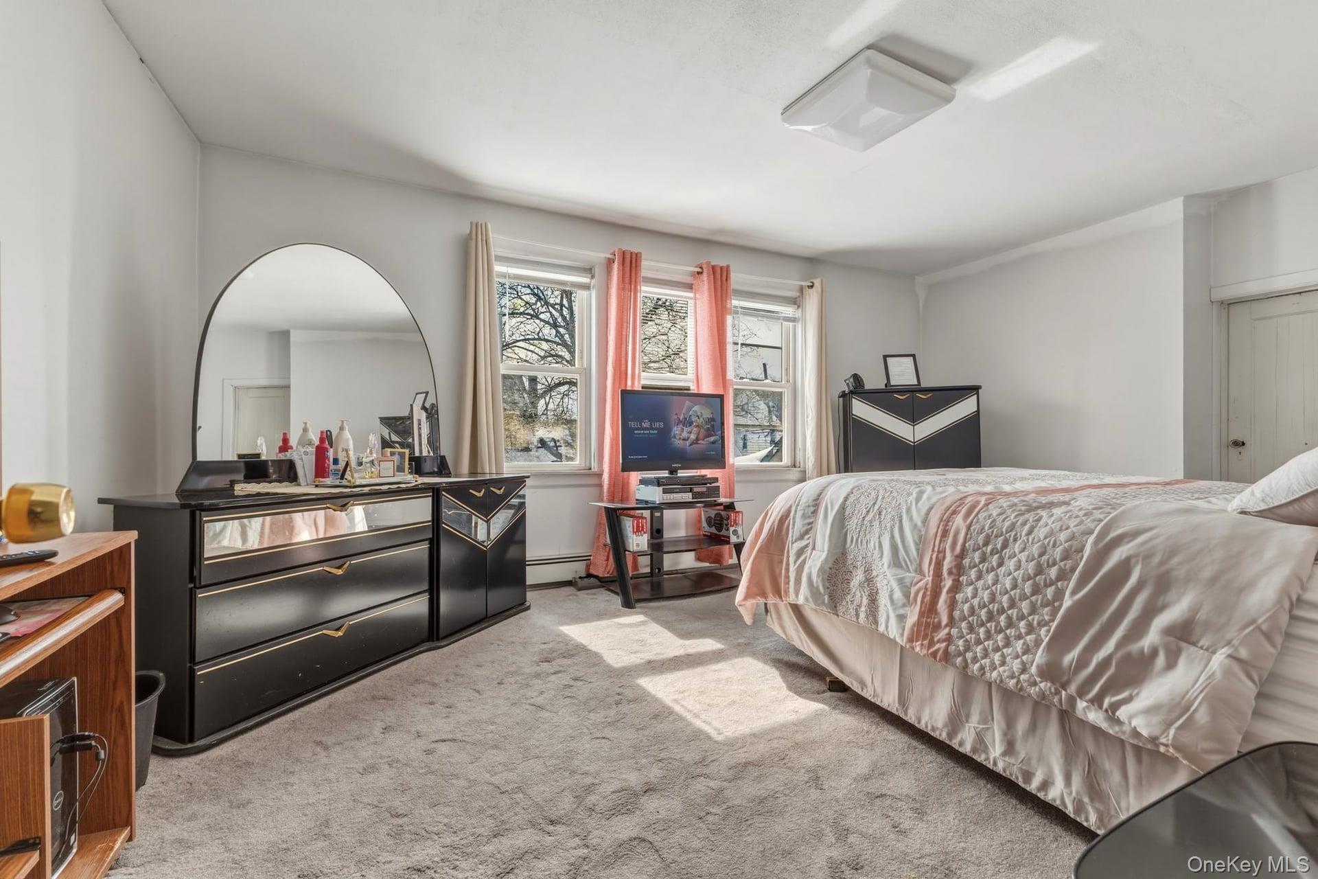 188-11 Dormans Road Queens, NY 11412 - Photo 25 of 32 a bedroom with a bed and a large window