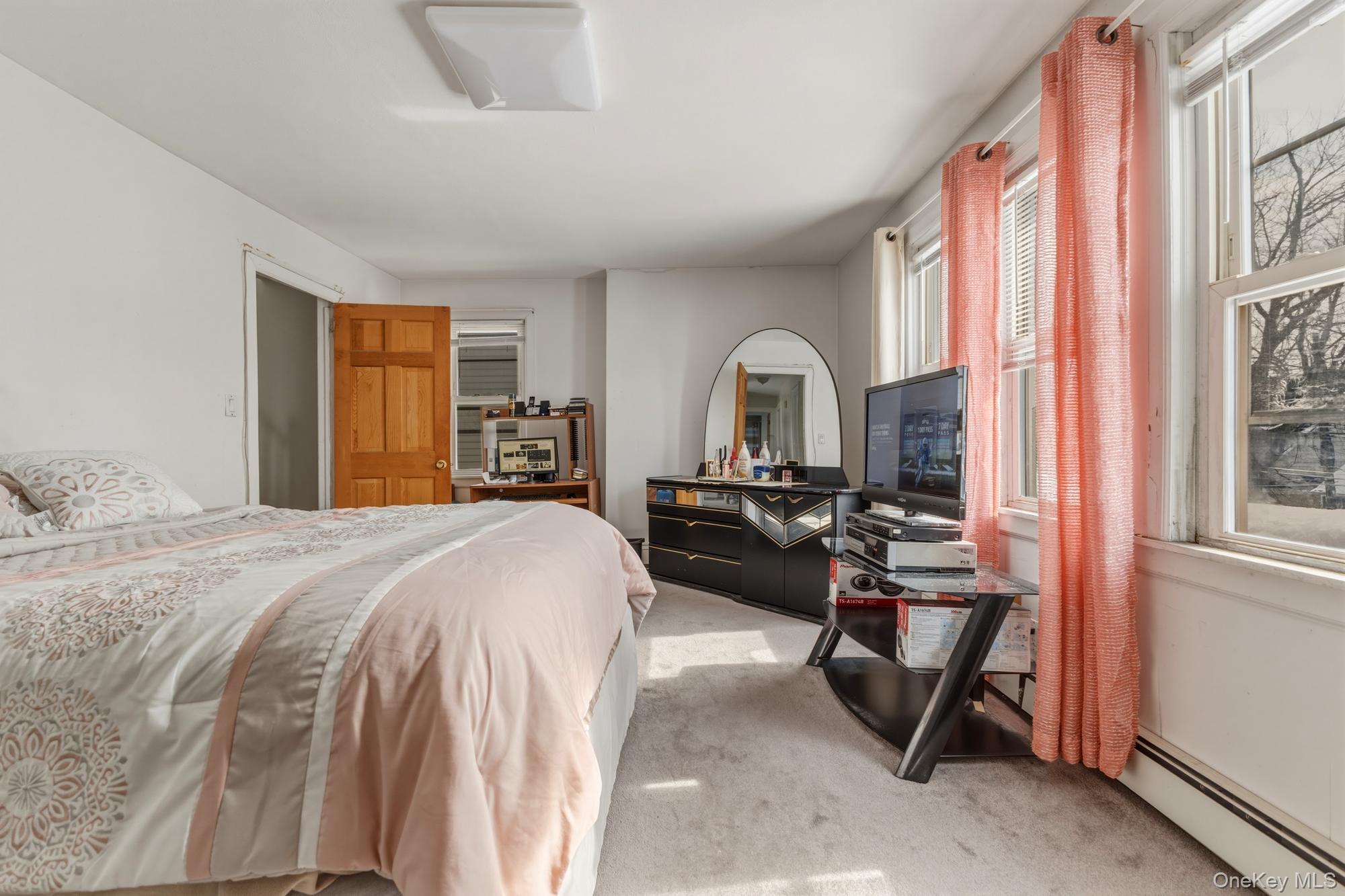 188-11 Dormans Road Queens, NY 11412 - Photo 26 of 32 a bedroom with a bed and a large window