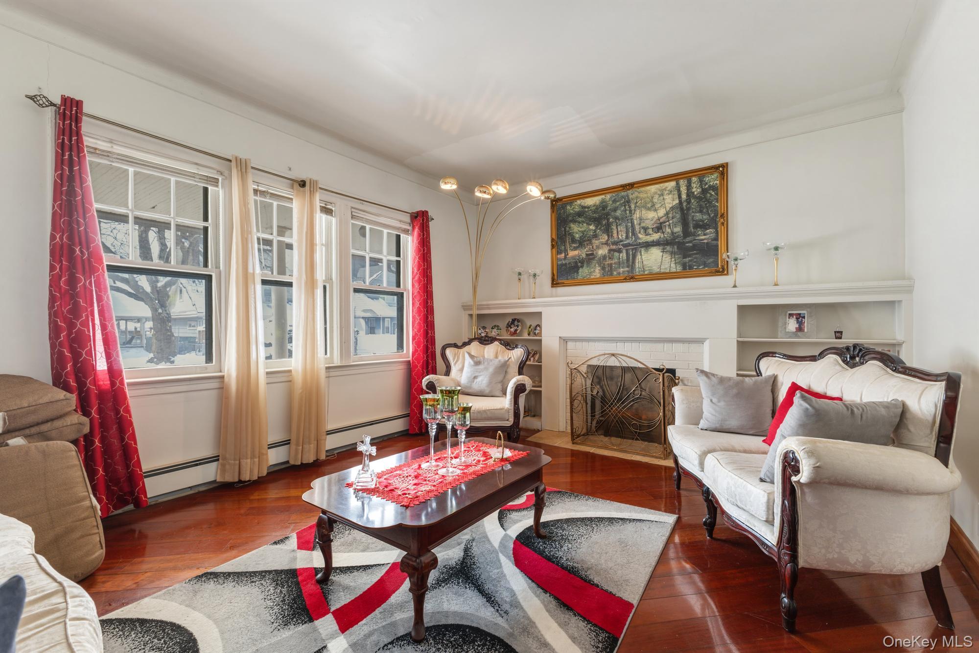 188-11 Dormans Road Queens, NY 11412 - Photo 3 of 32 a living room with furniture and a fireplace