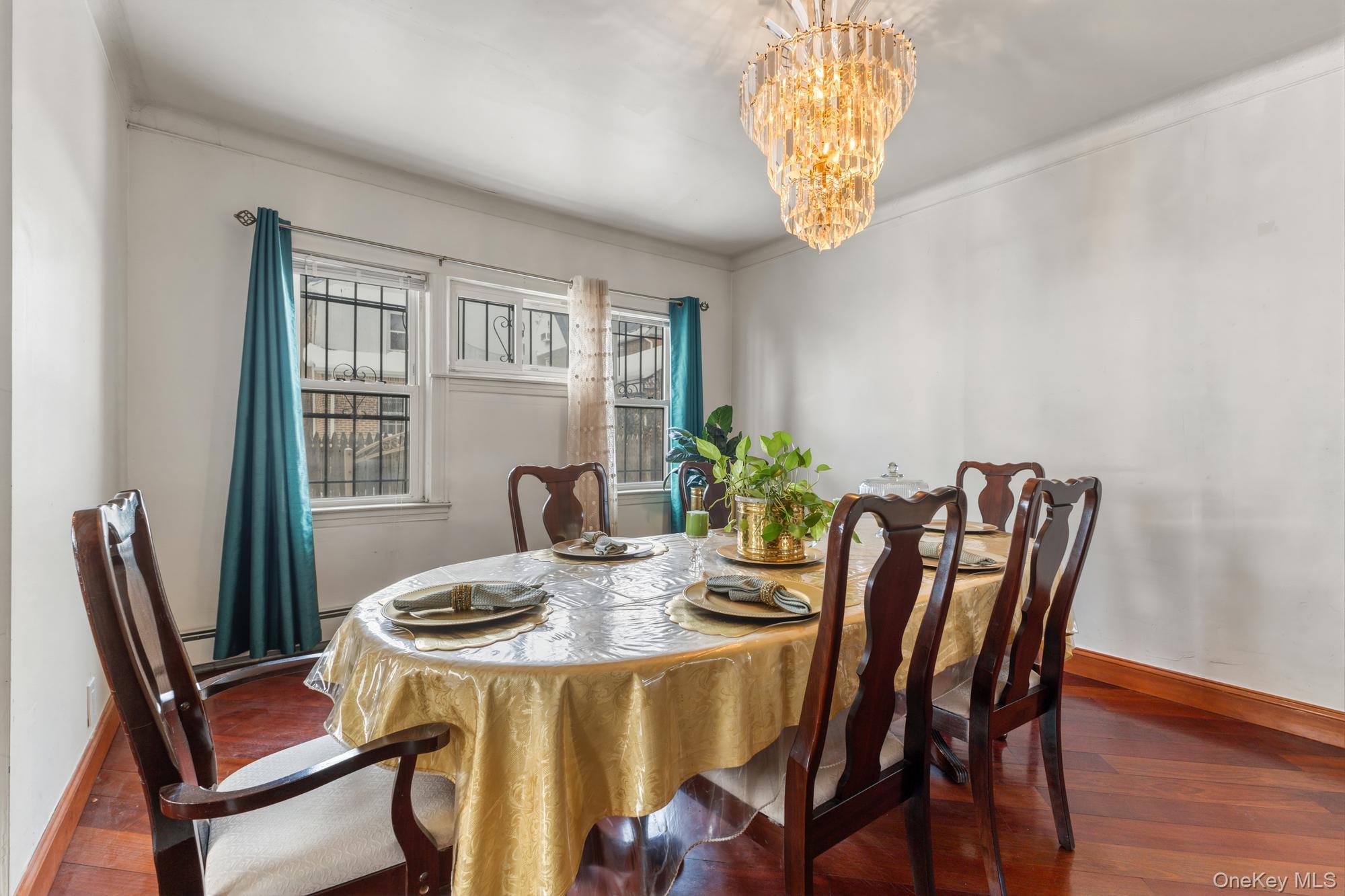 188-11 Dormans Road Queens, NY 11412 - Photo 6 of 32 a view of a dining room with furniture and chandelier